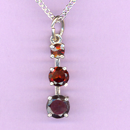 Silver 3 Stone GARNET  Pendant featuring: a 4mm,   5mm  and  a  6mm  GARNET on an 18" Silver Chain. Total Caret Weight: 1.7 cts.