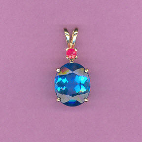 14kt Gold w/ 5ct 10x12mm Oval Cut Magnificent Deep Swiss Blue Topaz accented by a .09ct  Deep Red Ruby